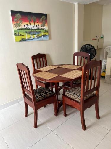 a wooden table with two chairs and a table and a table and chairsktop at Apto vista al mar en playa Rodadero in Santa Marta