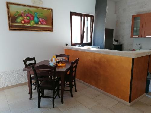 a table and chairs in a kitchen with a counter at B&B Masseria Spilafemine in Turi