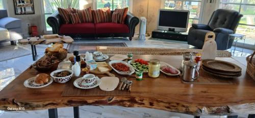 a coffee table with food on it in a living room at VIP Coco Oasis Villa in Tozeur