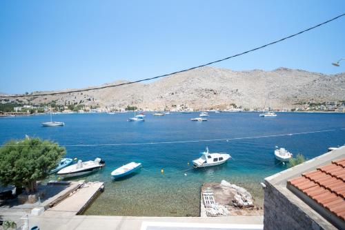 a group of boats in a large body of water at Mythos House - Seaside Retreat in Pedi in Symi
