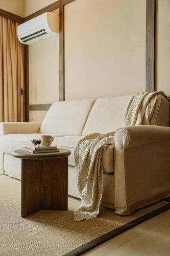 a living room with a white couch and a table at Raibu Ghent by StayC in Ghent
