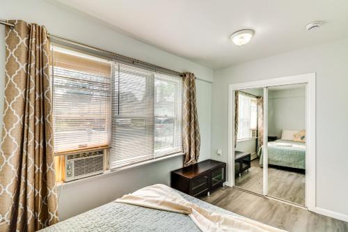 a bedroom with a window and a bed and a mirror at Cozy Keansburg Cottage Walk to Beach and Boardwalk! in Keansburg