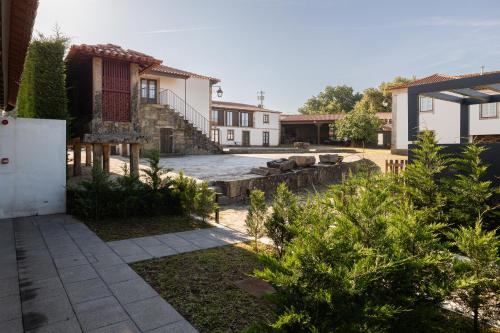a backyard with a pool and a house at CasaNova Farmhouse in Braga