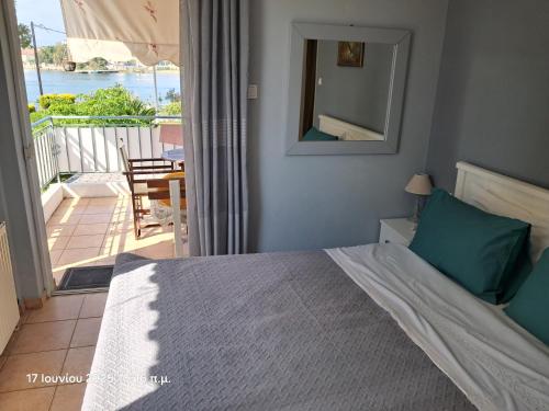 a bedroom with a bed and a view of a balcony at Top floor on villa, 3' from center, by the sea! Host is Efi Kwsta in Preveza