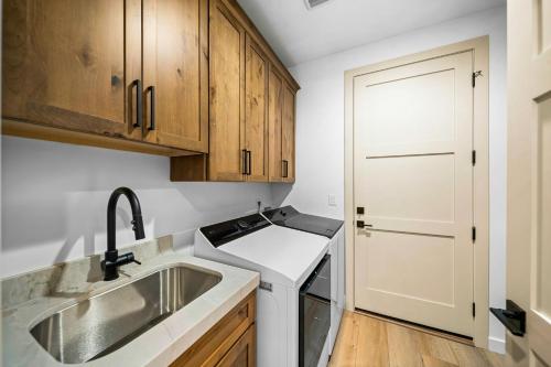 a kitchen with wooden cabinets and a sink at Lake-View Gem w/ Outdoor Entertainment in Show Low in Show Low