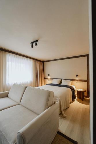 a hotel room with a bed and a couch at Raibu Ghent by StayC in Ghent