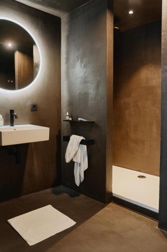 a bathroom with a sink and a mirror at Raibu Ghent by StayC in Ghent