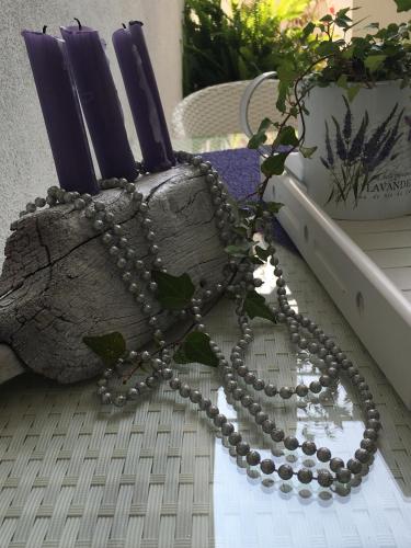 a rosary sitting on a table next to a plant at Casa di Lavanda in Hvar