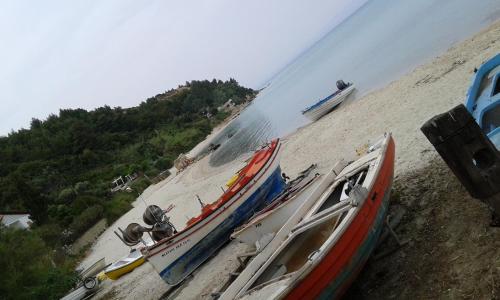a group of boats on a sandy beach at Apartmani Vila Marija in Budva