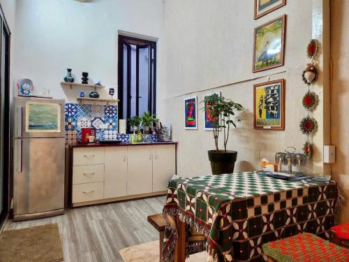 a kitchen with a table and a refrigerator at Hanoian Traditional Stay - City view - Old Quarter in Hanoi