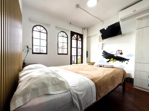 una camera da letto con un grande letto con un uccello sul muro di Hostel Prada a Lima