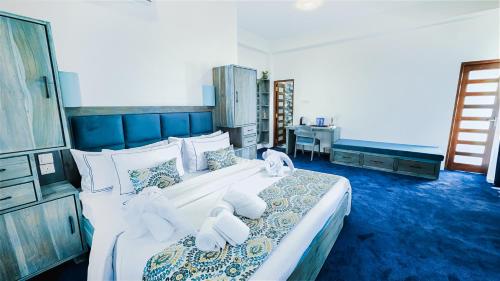 a bedroom with a large bed with towels on it at Hasthi Boutique in Kandy