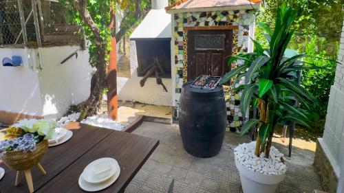 a patio with a table and plants and a fireplace at Casa Rural El Rincón del Júcar in Jorquera