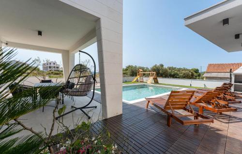 a patio with chairs and a swimming pool at Cozy Home In Turanj With Sauna in Turanj