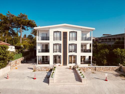 a white building with orange traffic cones in front of it at Tikir House in Pamukkale
