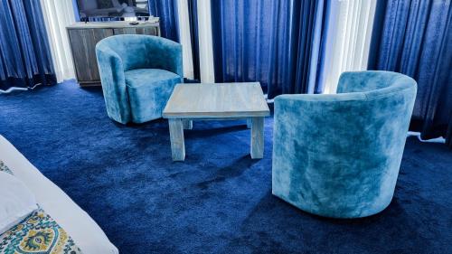a room with two chairs and a coffee table at Hasthi Boutique in Kandy