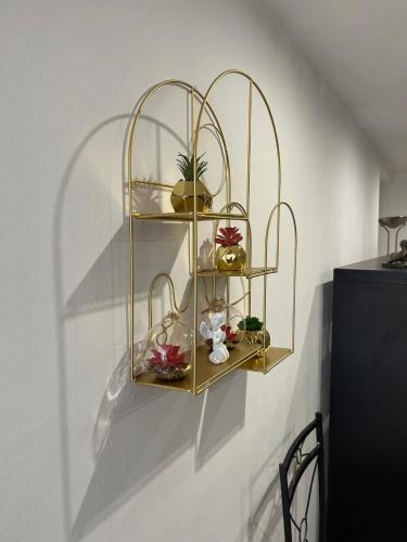 une étagère dorée sur un mur avec des décorations dessus dans l'établissement 