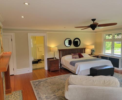 a bedroom with a bed and a ceiling fan at Shaughnessy Heritage Manor on Vancouver's Westside free housekeeping optional in Vancouver