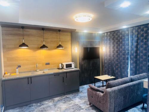 a kitchen with a couch and a microwave in a room at Tikir House in Pamukkale