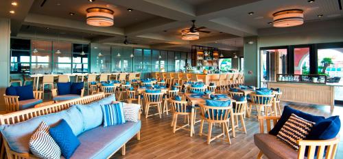a restaurant with tables and chairs and a bar at The Don CeSar in St Pete Beach