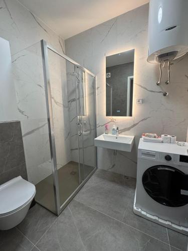 a bathroom with a shower and a toilet and a sink at Divna-Besplatan parking in Banja Luka