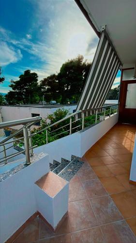 a balcony of a house with a table and railing at Vila Luani 1 in Vlorë