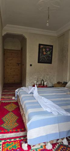 a bedroom with two beds and a rug at Dar Nourdine in Imlil