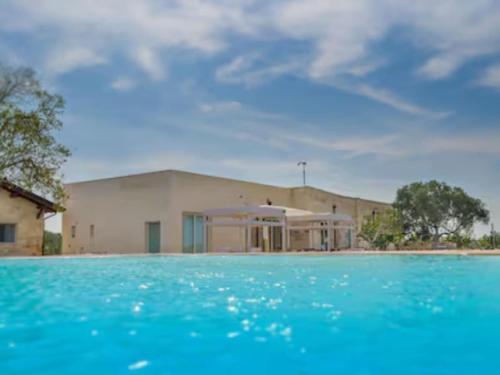 a building with a pool of water in front of it at Private Villa with pool in Merine