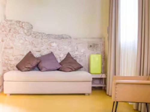 a living room with a couch with pillows on it at Private Villa with pool in Merine