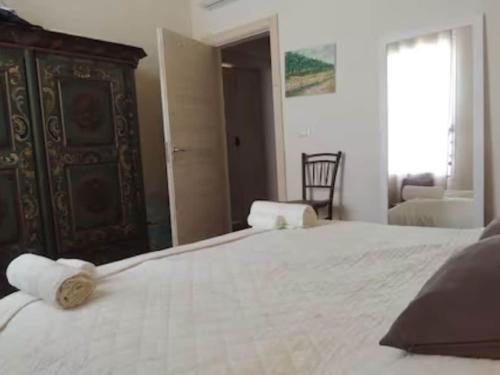 a bedroom with a large white bed with a wooden headboard at Private Villa with pool in Merine