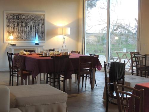 a dining room with a table and chairs at Private Villa with pool in Merine