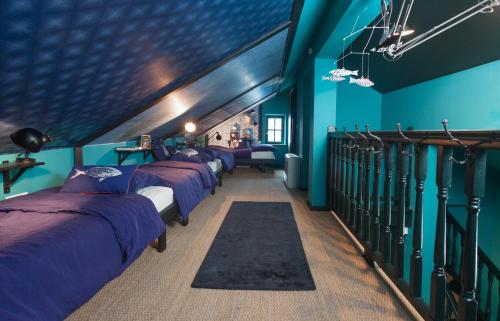 a row of beds in a room with blue walls at Villa Amarina in Trogir