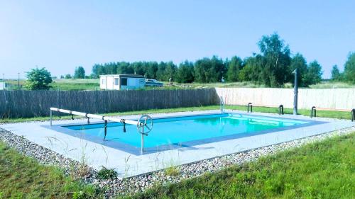 a swimming pool in a yard with a fence at Casa Luisa - Trzęsacz in Trzęsacz