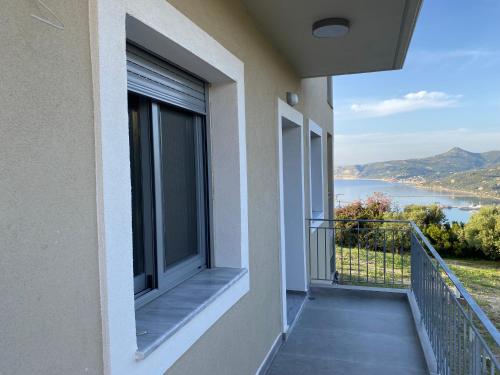 a balcony of a building with a view of the water at Aegean Panorama in Paralía Kímis
