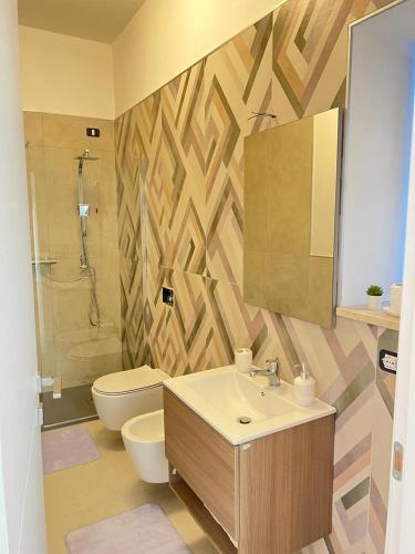 a bathroom with a sink and a toilet and a mirror at GOLDEN HILLS VIEW, Pierina's house in Bonnanaro