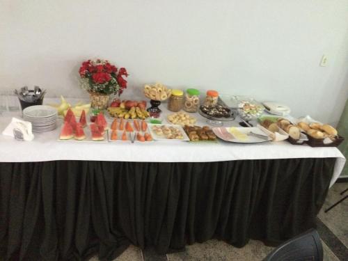 a table with a buffet of food on it at Cristal Park Hotel in Cristalina