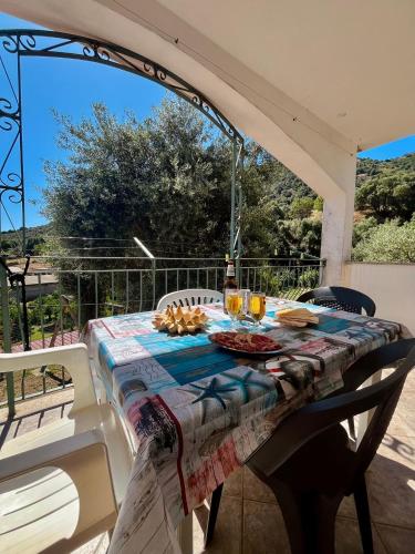 a table with a plate of food on a patio at Appartamento Sa Funtana in Cardedu