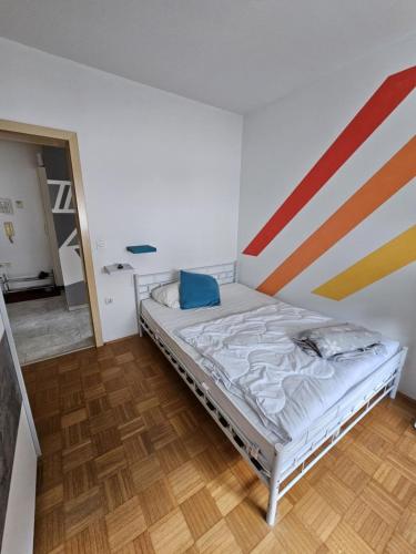 a bed in a room with a striped wall at Designer apartment in nature in Vojnik