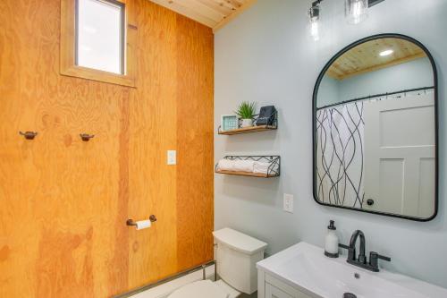 a bathroom with a mirror and a toilet and a sink at Garden City Home with Fire Pit Walk to Bear Lake! in Garden City