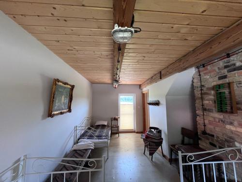 a room with two bunk beds and a stone wall at Dom przy saunie - Osada u Mniszki in Knyszyn