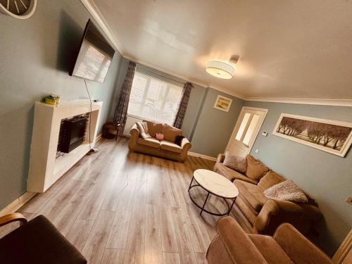 a living room with a couch and a fireplace at This guest house not ready please don t book me in Glasgow