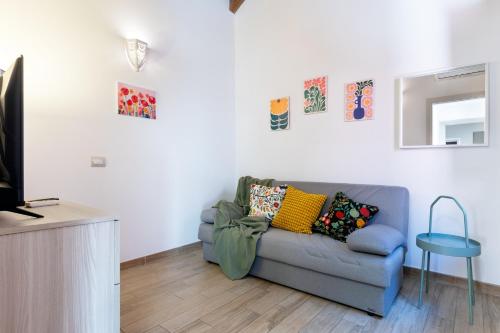a living room with a couch and a television at GuestHost - My Little Pink House in Selargius