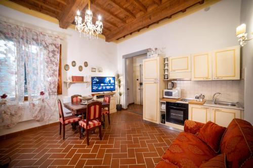 a living room with a table and a kitchen at Ricale in Florence