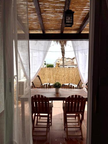 a table and chairs sitting on a patio with a table and a table at El Ático de Vera in Vera