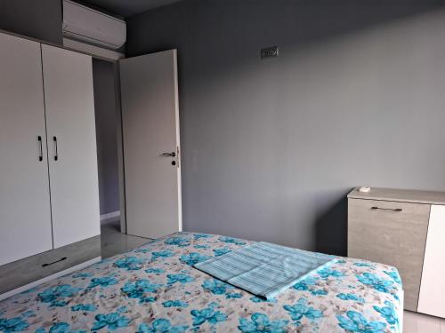 a bedroom with a bed with a quilt on it at MariGold Villa in Prinos