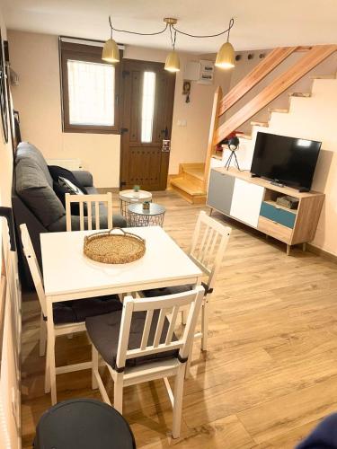 a living room with a table and a couch at El Casillo de Gredos in Navacepeda de Tormes