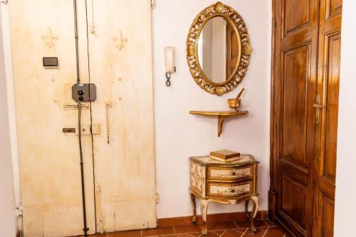 a room with a mirror on the wall and a table at Ricale in Florence