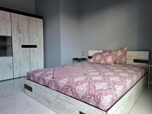 a bedroom with a large bed with a wooden headboard at MariGold Villa in Prinos