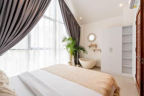a bedroom with a bed and a large window at Sunrise Bliss 2 in Dalung