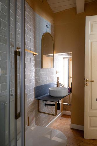 a bathroom with a sink and a mirror at Guest house SAL E PEDRA in Villanueva de Arosa